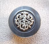 Metal effect crest button